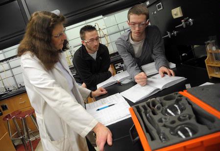 Dr. Sally Henrie helps students with a chemistry lab assignment. - Photo by Morris Abernathy