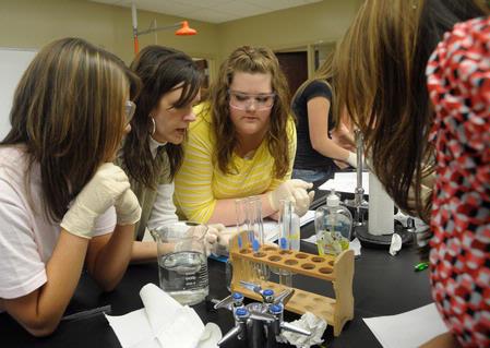 Tamara Popplewell, instructor of biology, helps her students with a biology lab experiment.  - Photo by Morris Abernathy