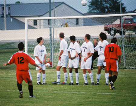 Fabio Buarque (12) attempts a free kick over a wall of defenders.  Kekec Zivkovic (10) looks on. - Photo by Uncredited