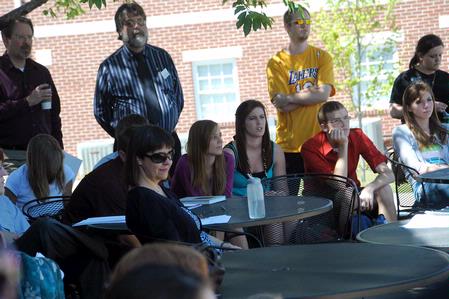 Faculty and students listen to English majors present their semester long projects outside Barefoots Joe for the annual scholarship symposium. - Photo by Morris Abernathy