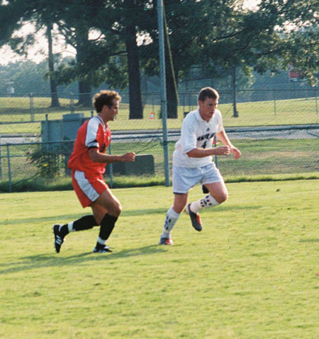 Kyle McDiarmid (8) an opponent in pursuit of the ball. - Photo by Uncredited