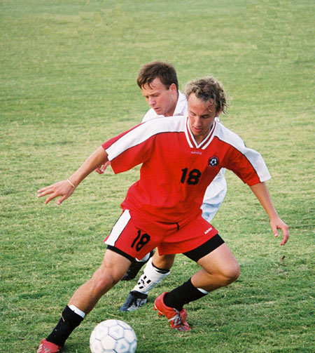 Christopher Printice (18) displays great footwork as he keeps the ball from a defender. - Photo by Uncredited