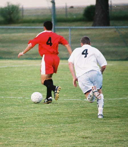 Redzi Stojiljkovic (4-Red) wins the ball and advances toward the goal. - Photo by Uncredited