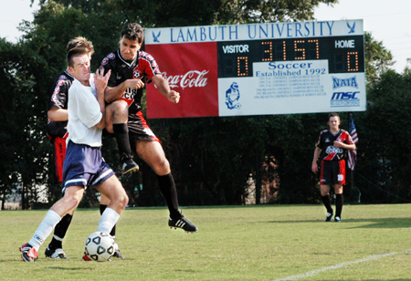 Union's Alexandre Pereira colides with Lambuth player in a soccer match.  Union won the match 3-0. - Photo by Justin Veneman
