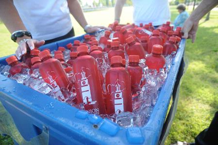 Over 1000 bottles of ice water were handed out to graduates and family at this year's summer graduation, held on the Great Lawn. - Photo by Morris Abernathy