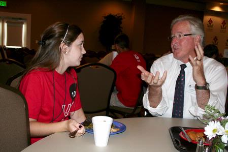 Jim Veneman, assistant professor of communication arts, talks with incoming freshmen during the Dinner with your Department event. - Photo by Deanna Santangelo