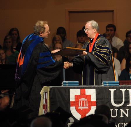 President David S. Dockery presents Jimmy Davis, vice president for the regional campuses, with a plaque in honor of his new role at the university.  - Photo by Morris Abernathy