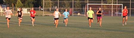 The ladies on the cross country team participate in a fun tradition coach Johnson started. At the beginning of the season they run laps barefoot to gain strength.  - Photo by Ebbie Davis