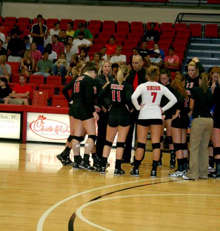 Kelly Elliot, head coach, and Ariel Apolinario, assistant coach, talk with the volleyball team during a game against Lyon College.  - Photo by Deanna Santangelo