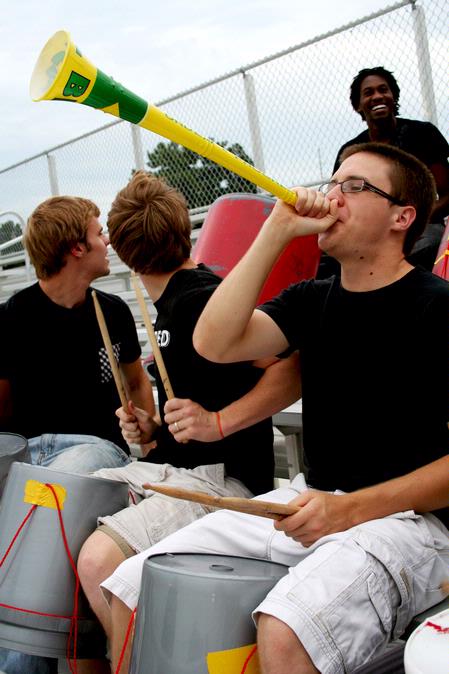 Curtis Schulz, sophomore applied linguistics major, plays the vuvuzela to cheer on the Lady Bulldog soccer team in a game against Webber International University. - Photo by Deanna Santangelo