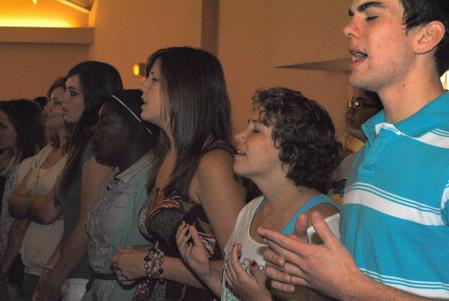 Jon Vunk, sophomore engineering major, and Hope Putman, sophomore social work major, sing with fellow students during chapel.  - Photo by Victoria Stargel
