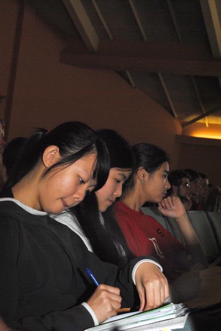 Kendra Loh, freshman psychology major, takes notes during GO week chapel.  - Photo by Victoria Stargel
