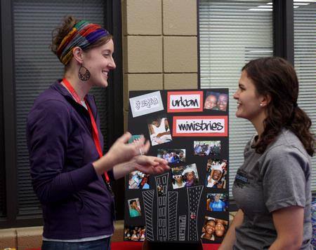 Julie Boyer, urban ministries coordinator at J Crib, talks to Rachel Donaldson, senior TESL major, about how students can get involved in Jackson's urban ministry. - Photo by Ebbie Davis