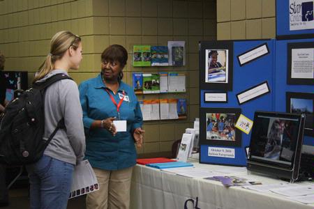 Amy White, senior nursing major, talks with a representative from Star Center in Jackson during GO Week at Union.  - Photo by Ebbie Davis