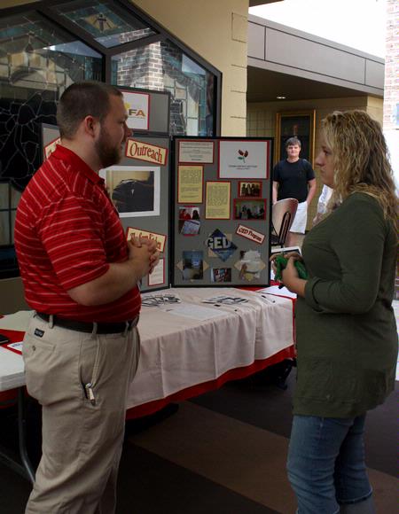 The annual GO Week gives students a chance to talk to local organizations about how they can get involved. Kevin Adelsberger, representative from RIFA and Union alum, talks to Jessica Duck, sophomore psychology major about opportunities at RIFA.  - Photo by Ebbie Davis
