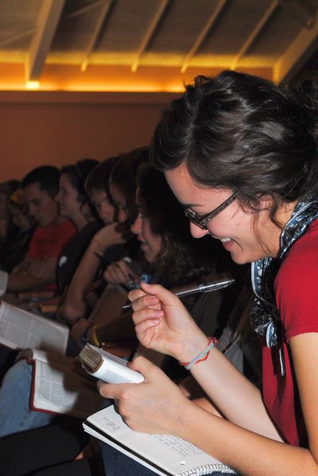 Abigail Ebensberger, sophomore Christian studies major, laughs as Dr. Gregory Thornbury, dean of the school of theology & missions, makes a quip during chapel. - Photo by Victoria Stargel