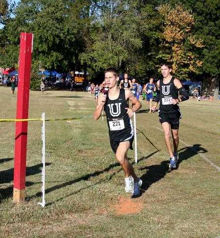 Drake Ott, sophomore athletic training major, and Logan Smith, sophomore, run in a cross country race.  - Photo by Deanna Santangelo