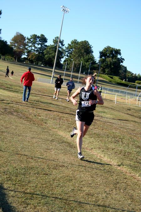 Carrie Moore, senior biology major, runs in a cross country meet.  - Photo by Deanna Santangelo