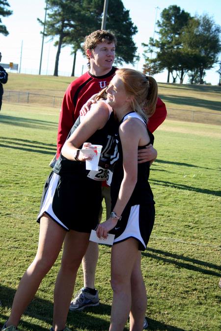 Carissa Wilson, senior elementary education major, hugs her teammate after a cross country meet.  - Photo by Deanna Santangelo