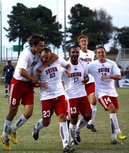 The Bulldogs celebrate a goal by Dejan Kostic (second from left) in a game against Mid-Continent University.  - Photo by Ebbie Davis