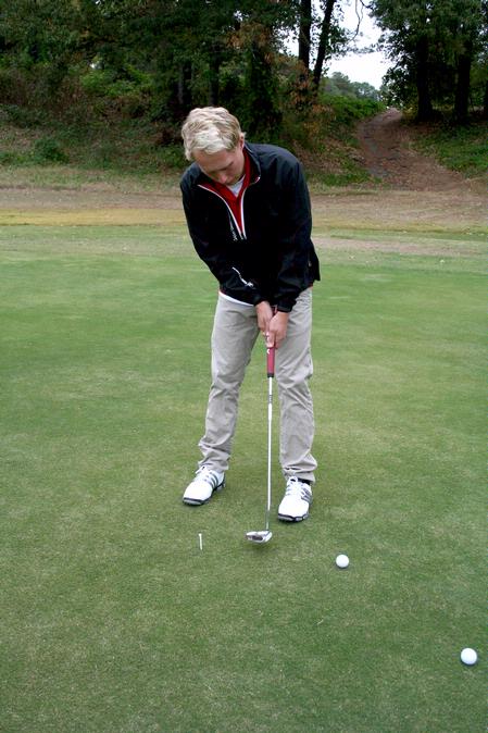 Jesper Swedenborg, junior business administration major, practices his putting during a Union golf practice. - Photo by Deanna Santangelo