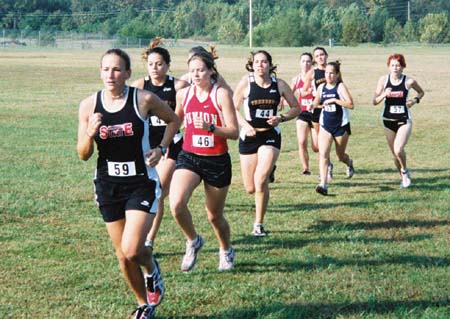 Freshman runner Jill Konkol of Union City runs close the front in the lead group.  Janelle Royer of Jackson also in the lead group. - Photo by Uncredited