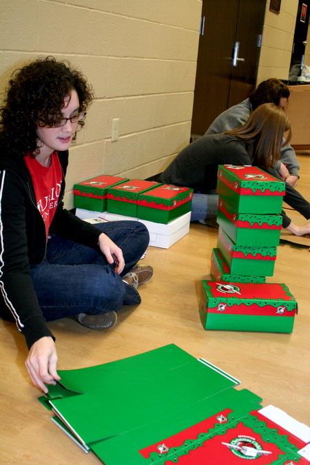 Amelia Seaton, freshman nursing major, helps assemble boxes for Operation Christmas Child during Campus and Community Day. - Photo by Deanna Santangelo