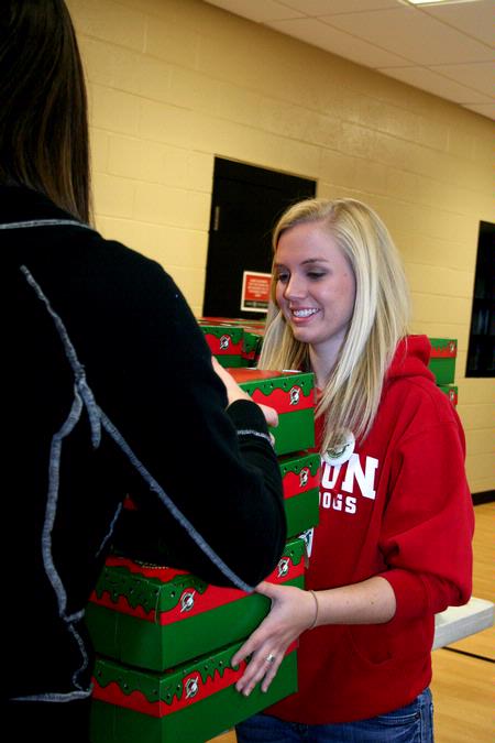 Sarah Chitwood, junior English and elementary education major, helps stack Operation Christmas Child boxes during Campus and Community Day.
 - Photo by Deanna Santangelo