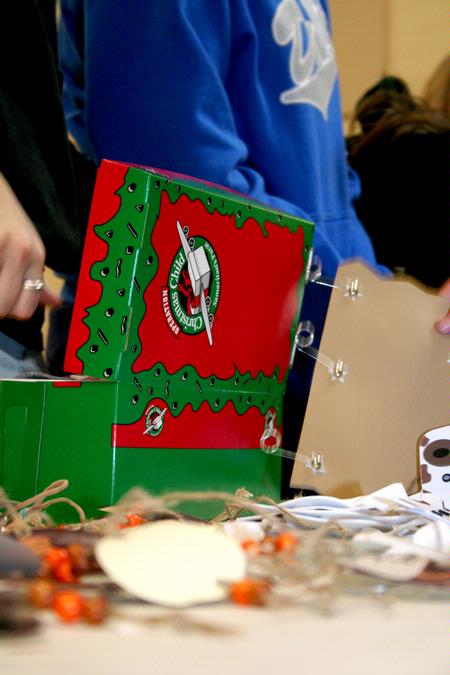 Students and faculty help pack Operation Christmas Child boxes for children in need during Campus and Community Day. - Photo by Deanna Santangelo