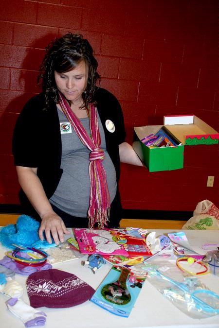 Ashley Jackson, resident director, packs a box for a child with Operation Christmas Child, which was one of many projects during Campus and Community Day. - Photo by Deanna Santangelo