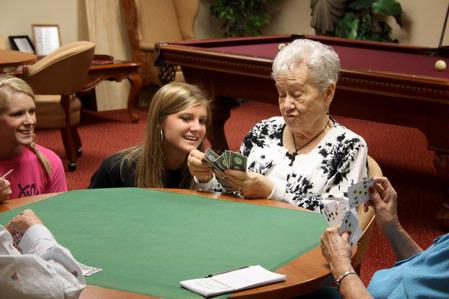 Savannah Whitted, senior chemistry major, visits with Jackson Meadow Retirement resident Doris Brown during Campus and Community Day. Brown encourages the women at Jackson Meadow to play bridge and teaches them the rules. - Photo by Ebbie Davis