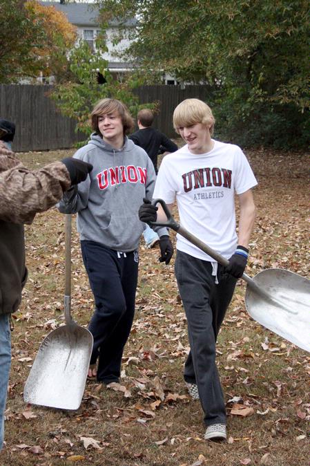 Freshmen Ben Erickson, psychology major, and Trevor Avery, biology major, volunteer their time at Liberty Garden Park for Campus and Community Day. - Photo by Ebbie Davis