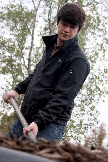 Team leader, Nic Seaborn, senior Christian studies major, shovels and lays mulch at Liberty Garden Park during Campus and Community Day.  - Photo by Ebbie Davis