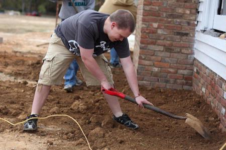 History students help in the restoration of an historic home in Casey Jones Village as part of Campus and Community Day. The historic home, called the Neil House, was relocated from Trenton, Tn. - Photo by Kristi McMurry Woody