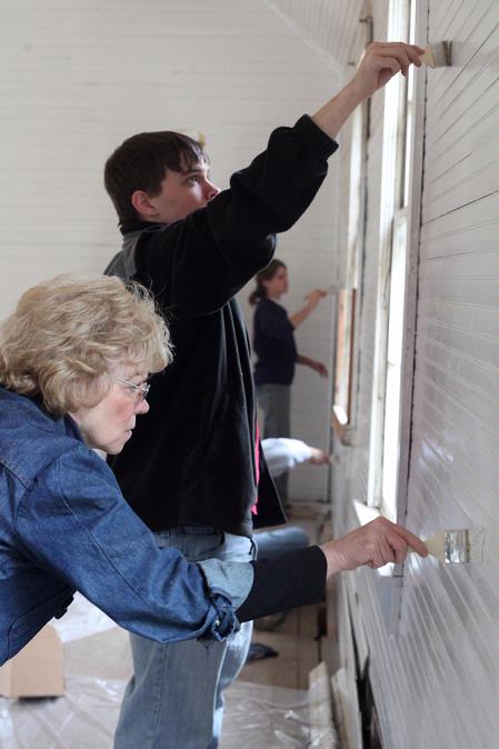 Judy Leforge, associate professor of history, and Michael Jones, freshman chemistry major, paint the walls of the historic church located at Casey Jones Village during Campus and Community Day.  - Photo by Kristi McMurry Woody