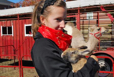 Emily Logan, senior music performance major, holds a rabbit at the petting zoo that was a part of the Homecoming festivities on the Great Lawn. - Photo by Abigail Harris