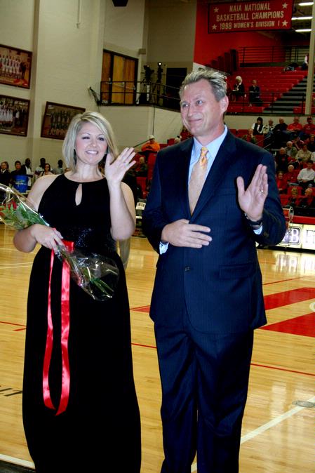 Stephanie Sowell, senior elementary education major, waves to the crowd as she is escorted in the homecoming court.  - Photo by Deanna Santangelo