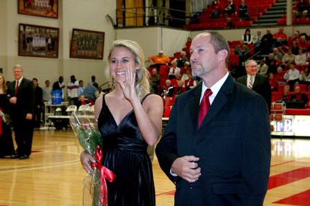 Brooke Laws, senior athletic training major, waves during the presentation of the homecoming court.  - Photo by Deanna Santangelo