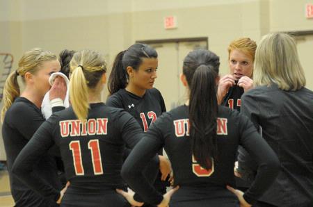 Union volleyball players take a timeout and get motivation from coach Kelly Elliot, assistant professor of physical education. - Photo by Morris Abernathy