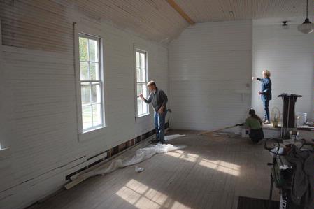 Students and faculty from the history department work on restoring a church in Casey Jones Village as part of Campus and Community Day.  - Photo by Morris Abernathy