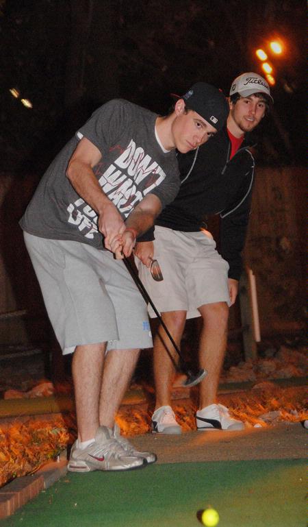 Ryan Substad, freshman engineering major, putts for the last hole at the men's Residence Life event, Puttapalooza. - Photo by Victoria Stargel