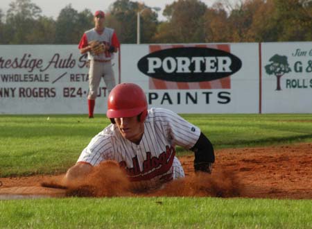 Seth Silcock dives back into first to avoid a pickoff attempt. - Photo by Steven Aldridge