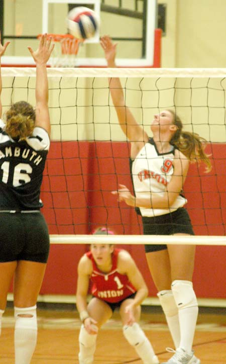 Freshman outside hitter Kelly Huffines goes for the kill in Union's 3-0 win over Lambuth.  Union's libero, Allison Shein (1) watches from the back line. - Photo by Steven Aldridge