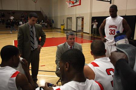 David Niven, head men's basketball coach, goes over a play during a time-out.  - Photo by Ebbie Davis