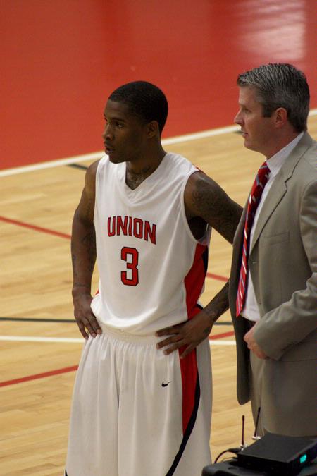 C.J. Davis and David Niven, head men's basketball coach, discuss a play on the sidelines during a game against Life University.  - Photo by Ebbie Davis