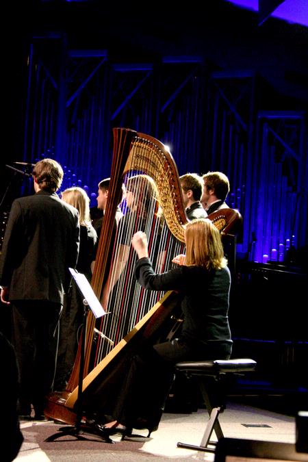 Anna Wicker, senior music major, plays the harp with the choral group, Proclamation, at A Union Christmas. - Photo by Deanna Santangelo