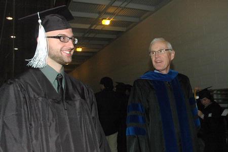 Cory Poston, Christian studies graduate, and James Patterson, associate dean of the School of Theology & Missions, talk with other students from their department before the 2010 Fall Commencement Services.  - Photo by Beth Spain