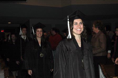 Katie Shatzer, journalism graduate, walks to her seat at the beginning of the 2010 Fall Commencement Services. 
 - Photo by Beth Spain