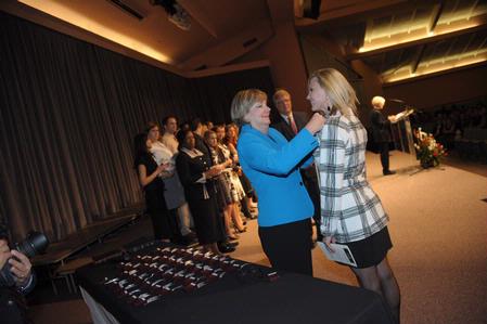 Denise Thornton-Orr, assistant professor of nursing in Germantown, helps pin nursing students during the annual pinning ceremony.  - Photo by Morris Abernathy