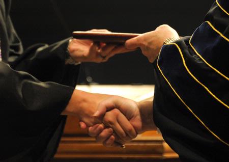 David S. Dockery, president of the university, confers degrees to graduates of Union University. - Photo by Morris Abernathy